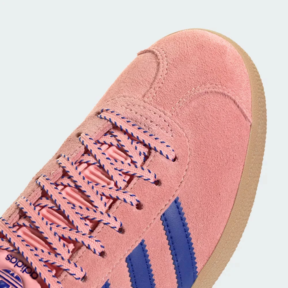 close-up of the fine pink suede grain and the precision stitching around the toe box.