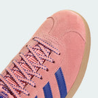 close-up of the fine pink suede grain and the precision stitching around the toe box.