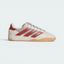 Highlights the high-velocity sweep of the Preloved Ruby 3-Stripes, the subtle gold-foil branding text, and the professional look of the textured gum rubber outsole walls.