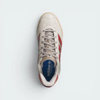 Focuses on the locked-in lace closure layout, the clean pattern configuration on the sculpted beige tongue, and the symmetry of the reinforced toe caps.