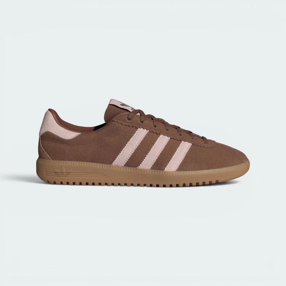Highlights the high-velocity sweep of the Sandy Pink serrated 3-Stripes and the professional, velvety depth of the Preloved Brown suede leading down to the translucent gum rubber sole.