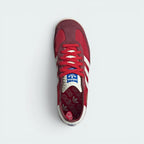 Focuses on the locked-in lace configuration, the high-definition dimpled textures of the retro tongue, and the symmetry of the suede toe guards.