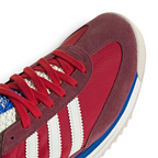 Details the premium stitching lines bonding the soft suede overlays to the lightweight nylon toe box.