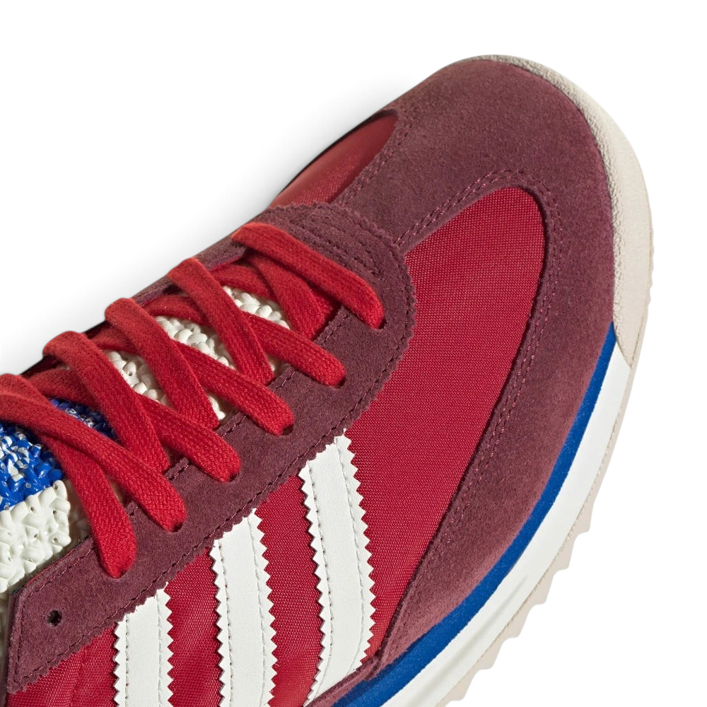 Details the premium stitching lines bonding the soft suede overlays to the lightweight nylon toe box.