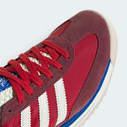 Details the premium stitching lines bonding the soft suede overlays to the lightweight nylon toe box.