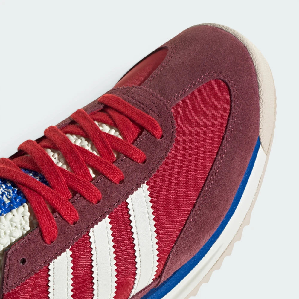 Details the premium stitching lines bonding the soft suede overlays to the lightweight nylon toe box.