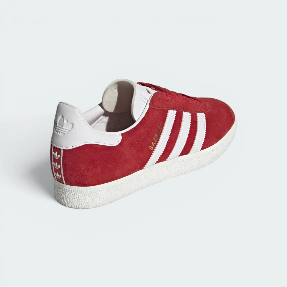 Focuses on the contoured shape of the white heel tab featuring the classic Trefoil logo and the clean finish of the sole casing.