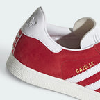 Highlights the "unreal" clean finish where the low-profile white rubber foxing tape bonds securely to the rich red upper.