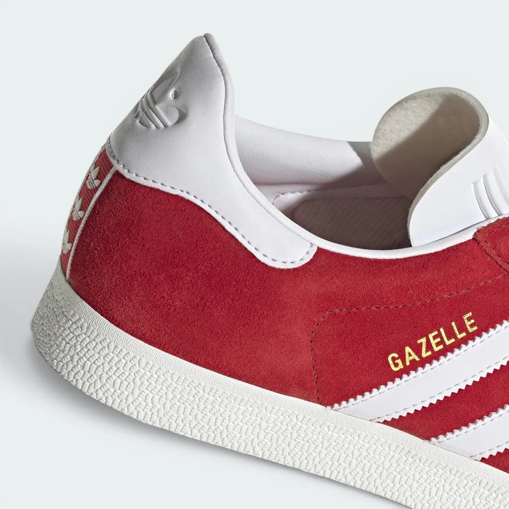 Highlights the "unreal" clean finish where the low-profile white rubber foxing tape bonds securely to the rich red upper.