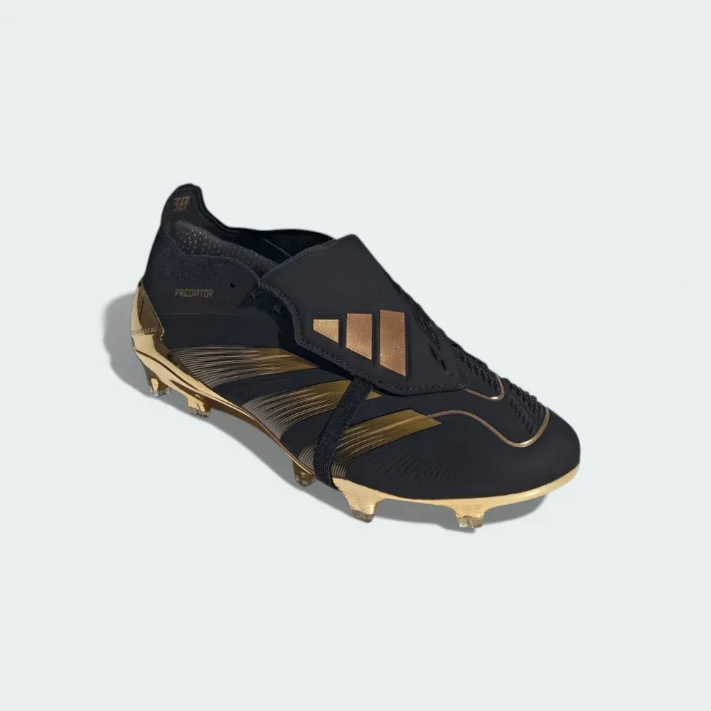 Three-quarter view of the boots, highlighting the contrast between the matte black HybridTouch 2.0 upper and the shimmering gold accents.