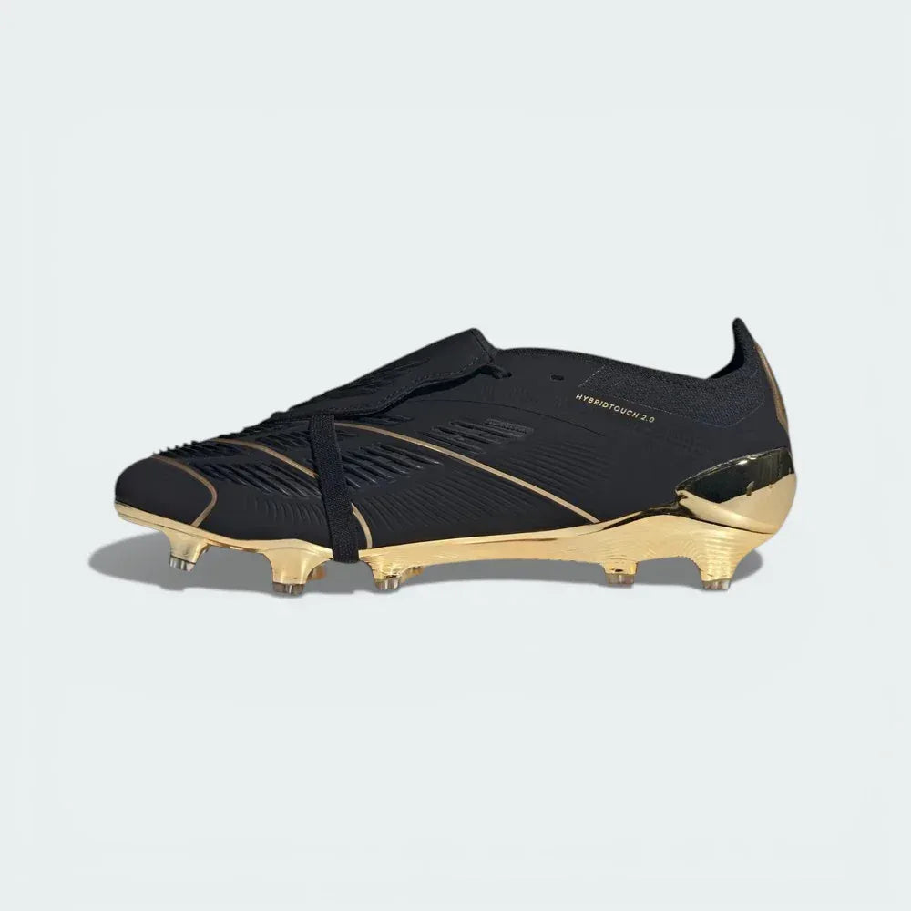 Black and gold soccer cleat on a light grey background