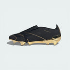 Black and gold soccer cleat on a light grey background