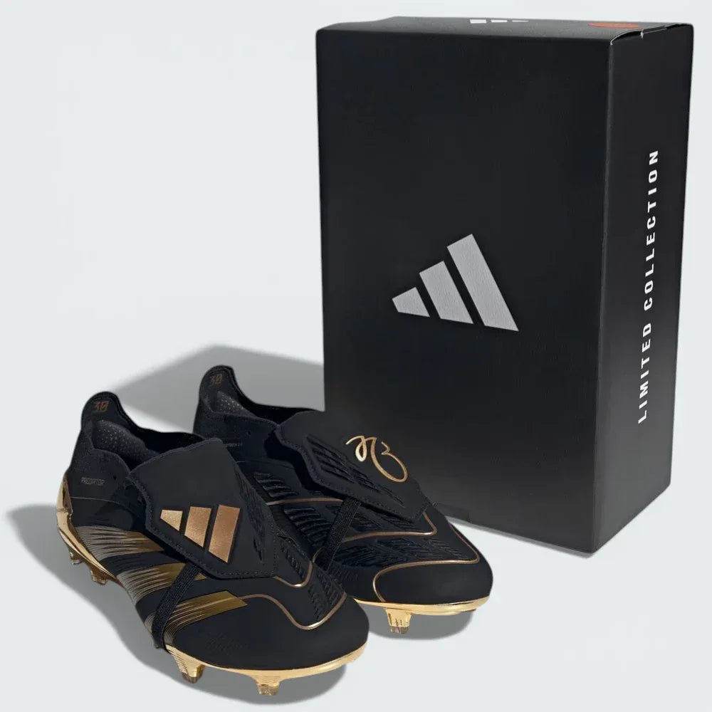 Black and gold cleats with a black Adidas box on a light grey background