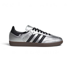Highlights the high-velocity sweep of the Core Black serrated 3-Stripes and the professional, gleaming depth of the high-shine Silver Metallic leather panels catching the light.