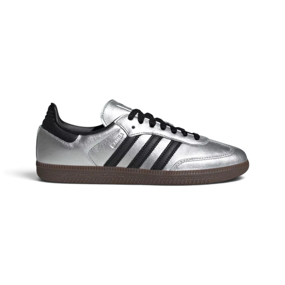 Highlights the high-velocity sweep of the Core Black serrated 3-Stripes and the professional, gleaming depth of the high-shine Silver Metallic leather panels catching the light.