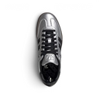Focuses on the tidy lace closure, the clean alignment of the metallic silver tongue, and the iconic T-toe configuration covering the front box.