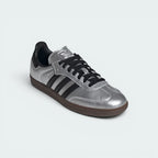 Emphasising the low-profile casual silhouette and the professional contrast of the dark black heel tabs against the reflective silver body.
