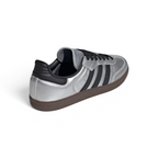 Focuses on the contoured shape of the black leather heel tab and the clean finish of the low-profile gum rubber sole stitching.