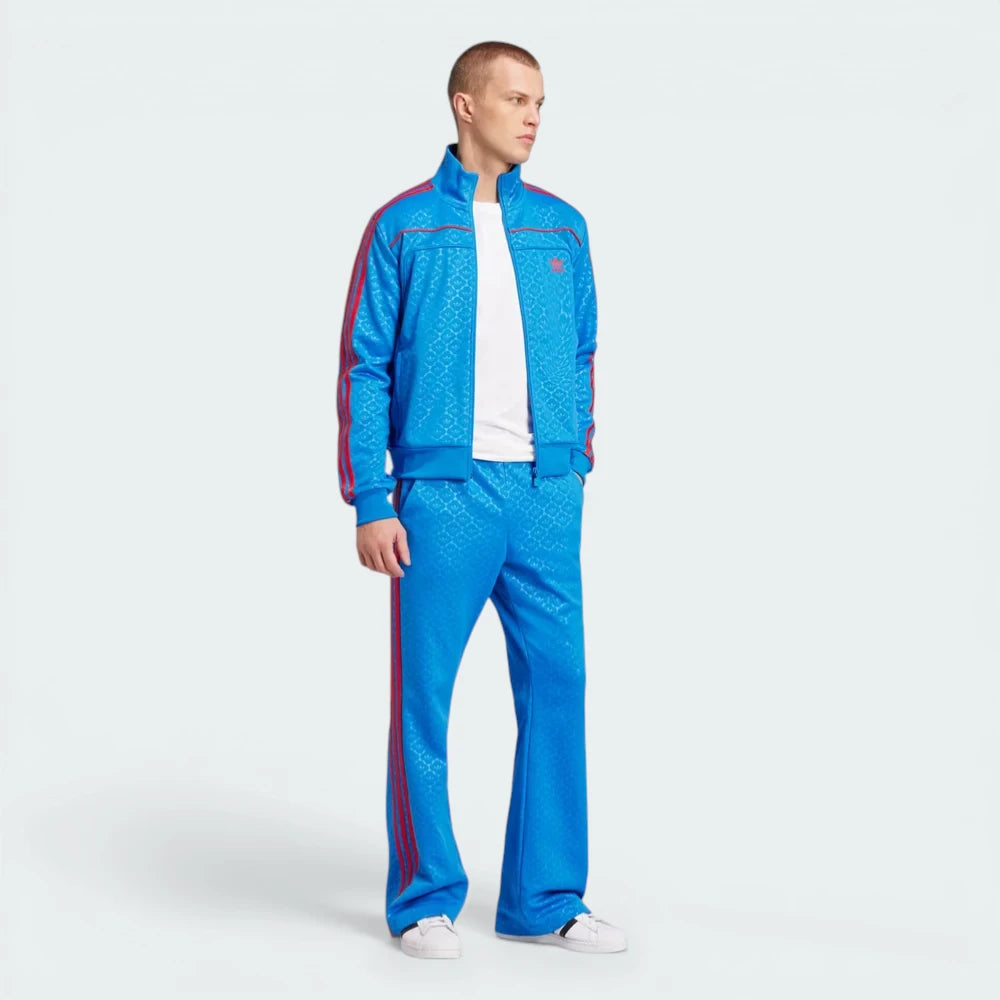 Man wearing a blue tracksuit with red accents on a white background