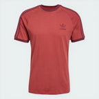 Top-down view of the tee laid flat, highlighting the contrast white ribbed crewneck and the embroidered Trefoil logo.