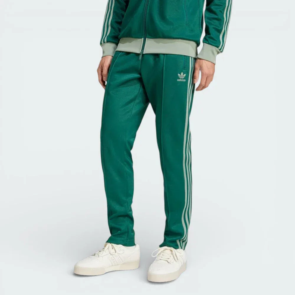 Front profile of the Collegiate Green adidas Beckenbauer track pants, highlighting the Silver Green 3-Stripes running down the leg.
