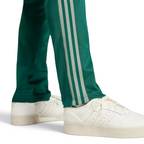 Close-up of the lower leg area, focusing on the high-quality stitching of the green stripes