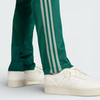 Close-up of the lower leg area, focusing on the high-quality stitching of the green stripes
