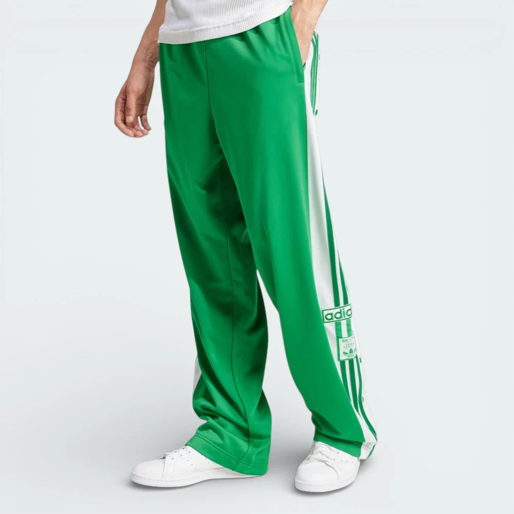 Side profile of the Green Adibreak pants, showing the full-length white snap-button panels and the iconic 3-Stripes.