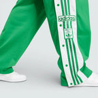 Close-up of the lower leg, focusing on the woven Adibreak patch and the high-quality metallic snap-button hardware