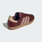 Focuses on the contoured shape of the Maroon leather heel tab and the clean finish of the low-profile gum rubber stitching.
