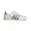 Highlights the sleek, low-profile lateral view showing the smooth Cloud White leather upper, deep Preloved Brown adidas Three Stripes, double-stitched T-toe overlay, flashing metallic accent details, and cream rubber sole.