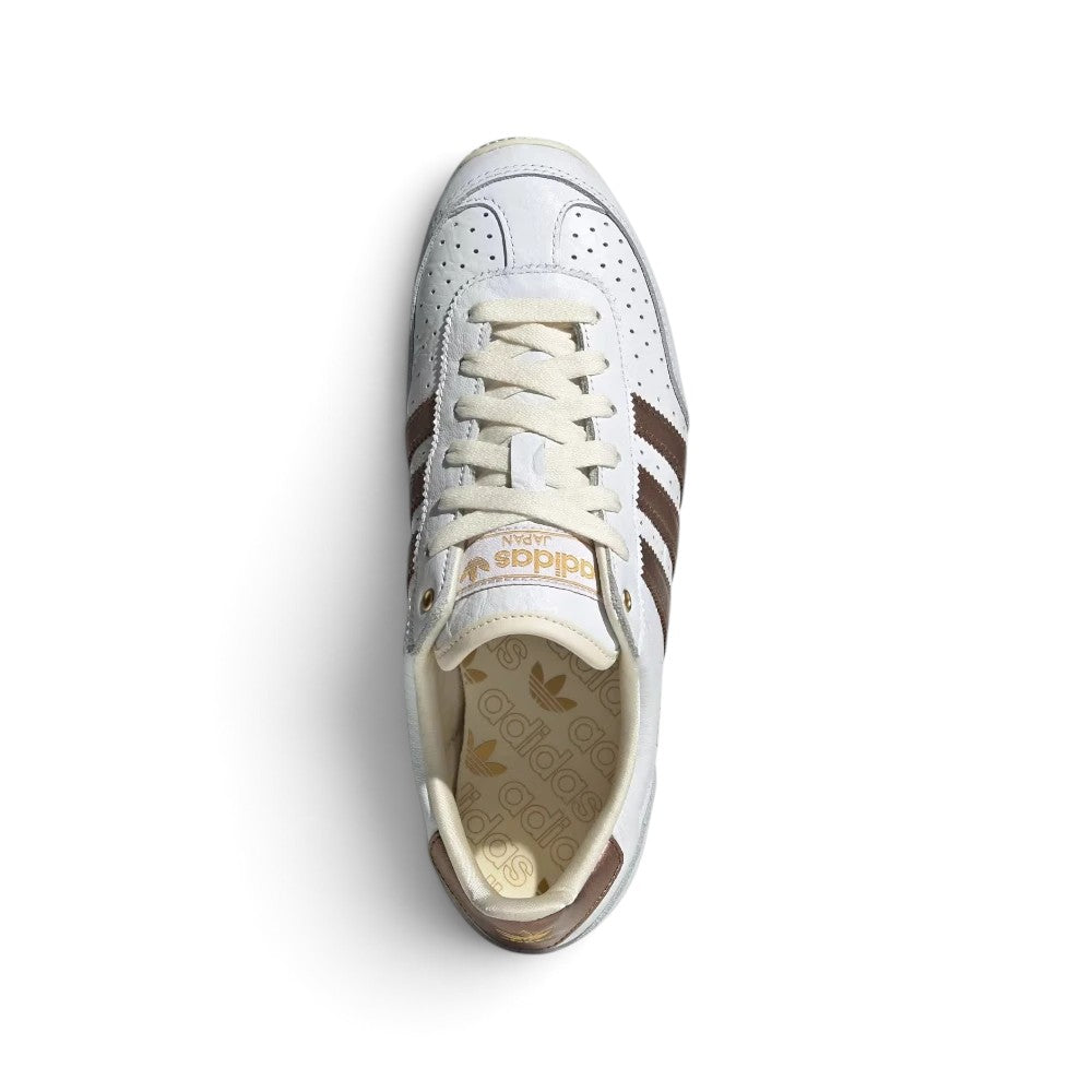 Focuses on the locked-in central lacing layout, displaying Cloud White laces, leather tongues printed with metallic Trefoil branding, soft synthetic collars, and insoles printed with adidas Japan logos.