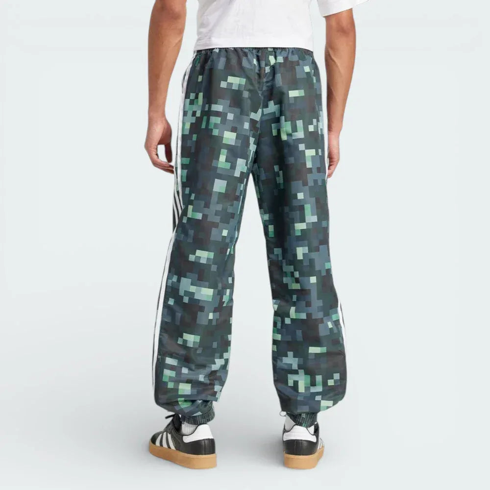 Rear view of the track pants, highlighting the clean finish of the Legend Ivy green and the structured fit.