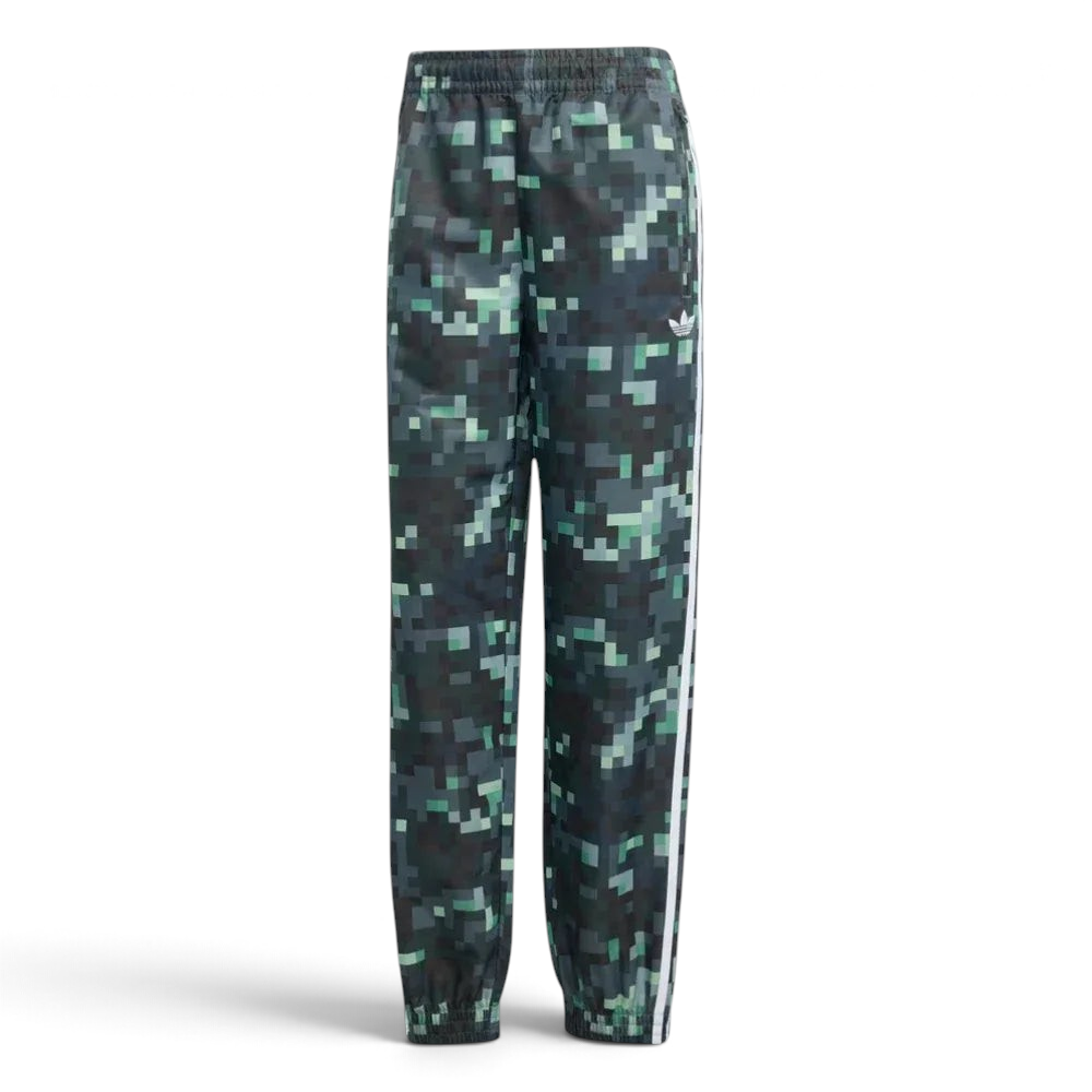 Forward profile of the adidas x Minecraft track pants, showing the colour gradient from light grey to dark green and the woven twill texture.