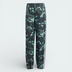 Forward profile of the adidas x Minecraft track pants, showing the colour gradient from light grey to dark green and the woven twill texture.