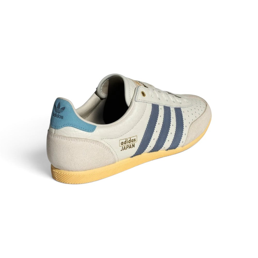 Focuses on the rear profile, highlighting the Preloved Ink navy leather heel tabs printed with gold or white Trefoil logos and the slim rubber heel wraps.