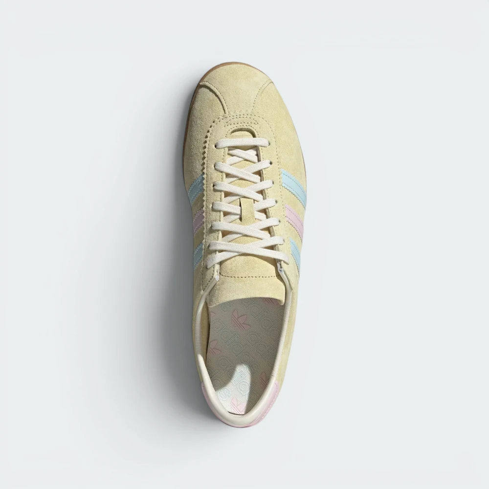Focuses on the clean lace closure, the high-definition texture of the Almost Yellow suede tongue, and the matching branded footbeds.