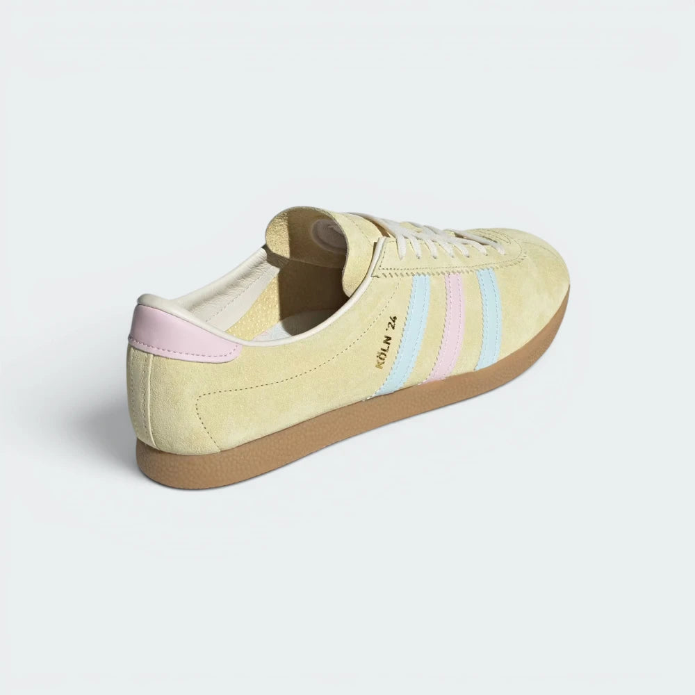 Focuses on the contrasting leather heel tab overlays and the clean finish of the low-profile rubber sole stitching.