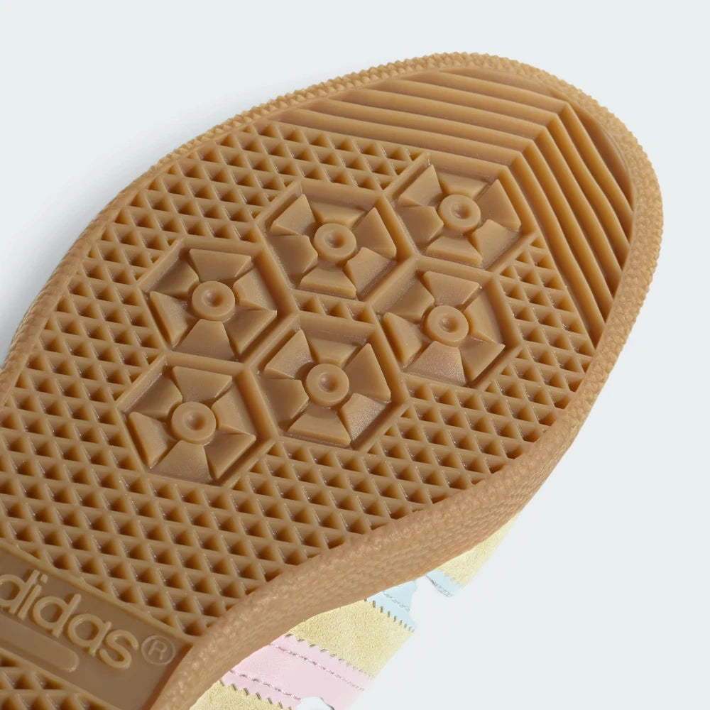 Close-up of Adidas shoe sole with textured pattern on a light background