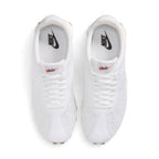 Overhead view of both sneakers showing the adaptive white knit forefeet, central lacing systems, and white insoles printed with black Nike branding.