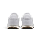 Rear view of the sneakers emphasizing the smooth leather heel tabs, flared sail midsoles, and brown waffle outsole edges.