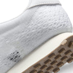 Close-up of the lateral heel transition, highlighting the smooth sail foam midsole, synthetic leather heel panel, and durable waffle tread pattern.