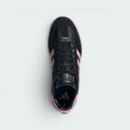 Focuses on the locked-in lace-up design layout, displaying the exact placement of the muted club crest on the tongue and the matching black suede toe cap guarding the front box.