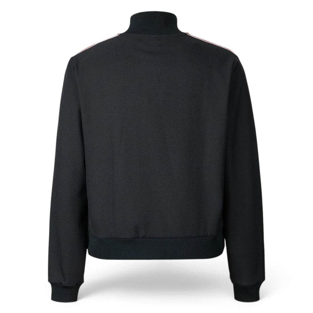 Rear-facing studio perspective of the black track jacket, showcasing the clean unbranded back panel, smooth twill fabric drape, and ribbed hem band.