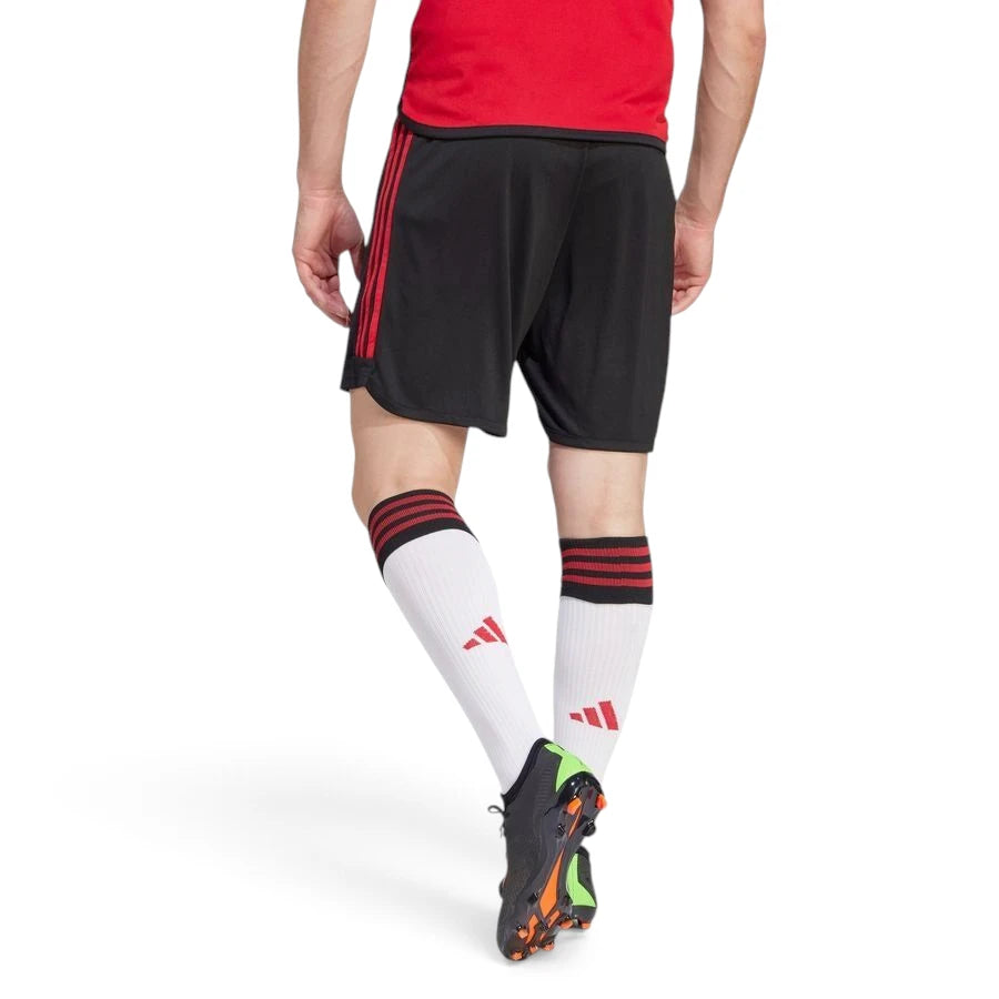 Rear studio perspective showcasing the clean black rear panel, regular fit drape, and continuation of the red side stripes down the legs.