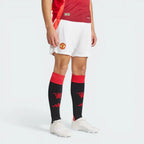 Person wearing a red sports jersey, white shorts with a logo, and black socks with a logo on a white background