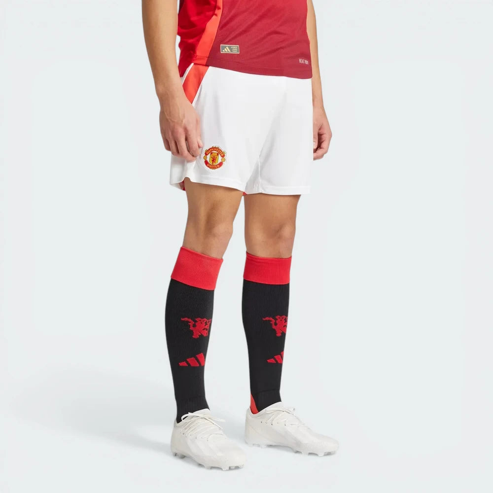 Person wearing a red sports jersey, white shorts with a logo, and black socks with a logo on a white background
