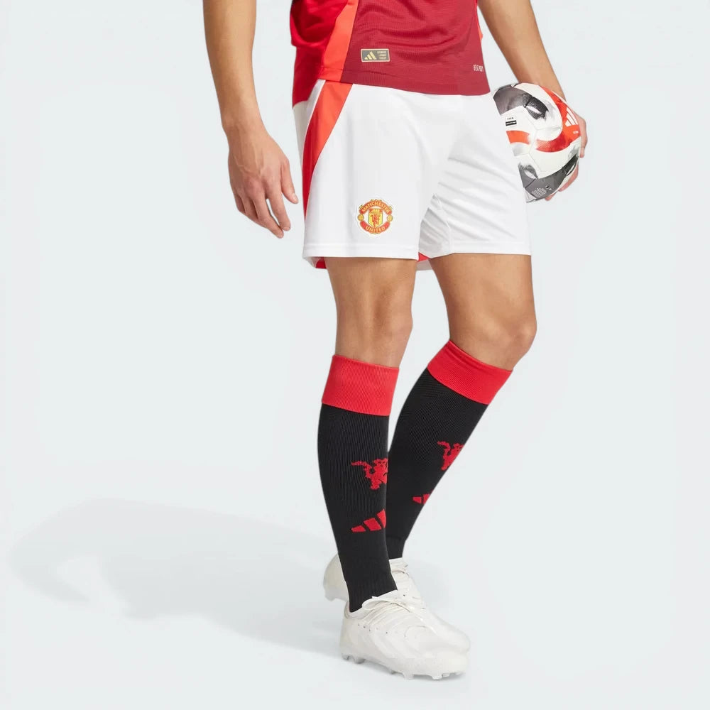 The White Man Utd shorts, highlighting the vibrant red Adidas 3-Stripes and the high-definition embroidered club crest. Main image