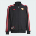 Top-down view of the jacket laid flat, highlighting the vintage sewn-on club crest and the contrast Trefoil logo on the chest.