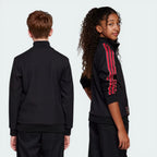 Side profile of the black Manchester United 80s Terrace Track Top, showcasing the slim fit and the ribbed texture of the stand-up collar.